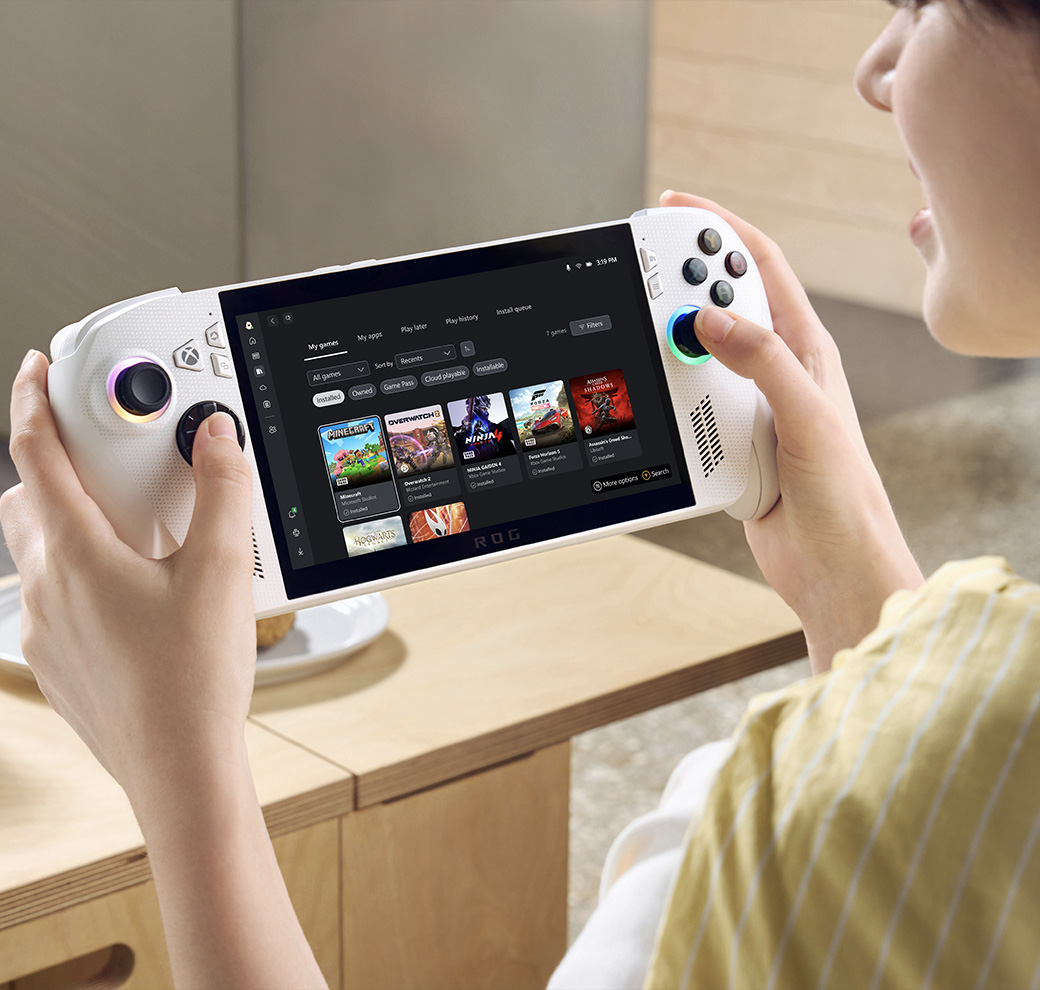 Gamer playing on the ROG Xbox Ally with headphones