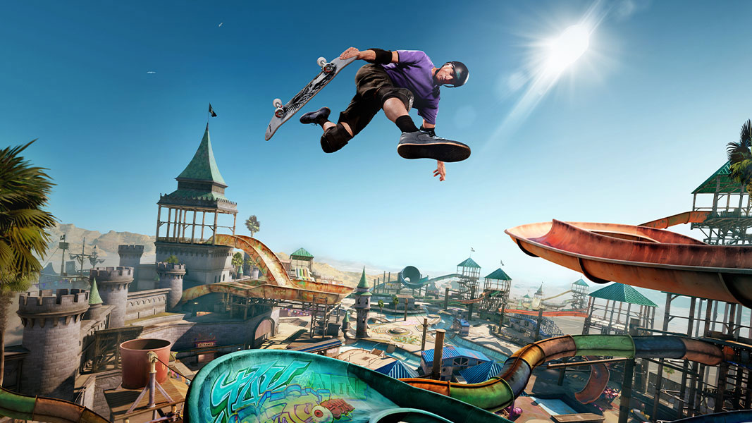 Tony Hawk airwalks over a ramp in an expansive skate park.