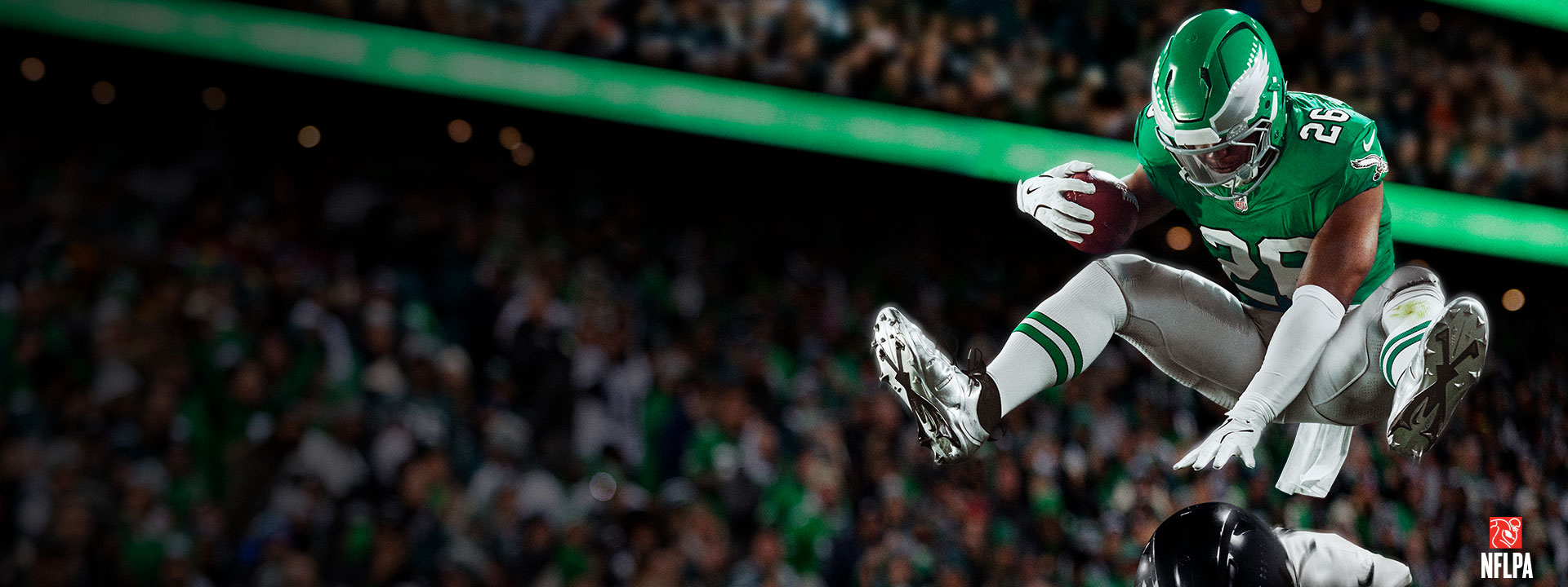 Saquon Barkley backwards hurdling another player in a stadium full of fans