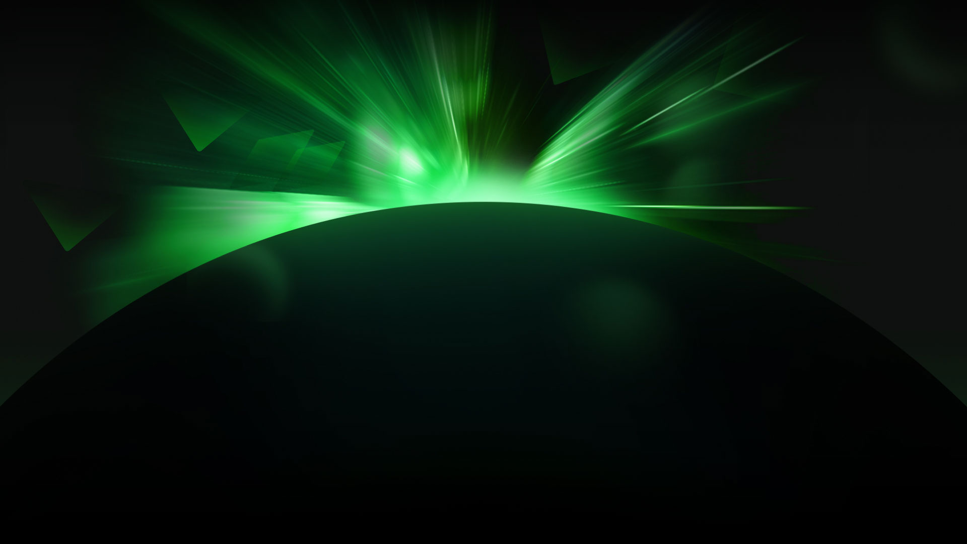 Bright green light surfacing from behind a black sphere.