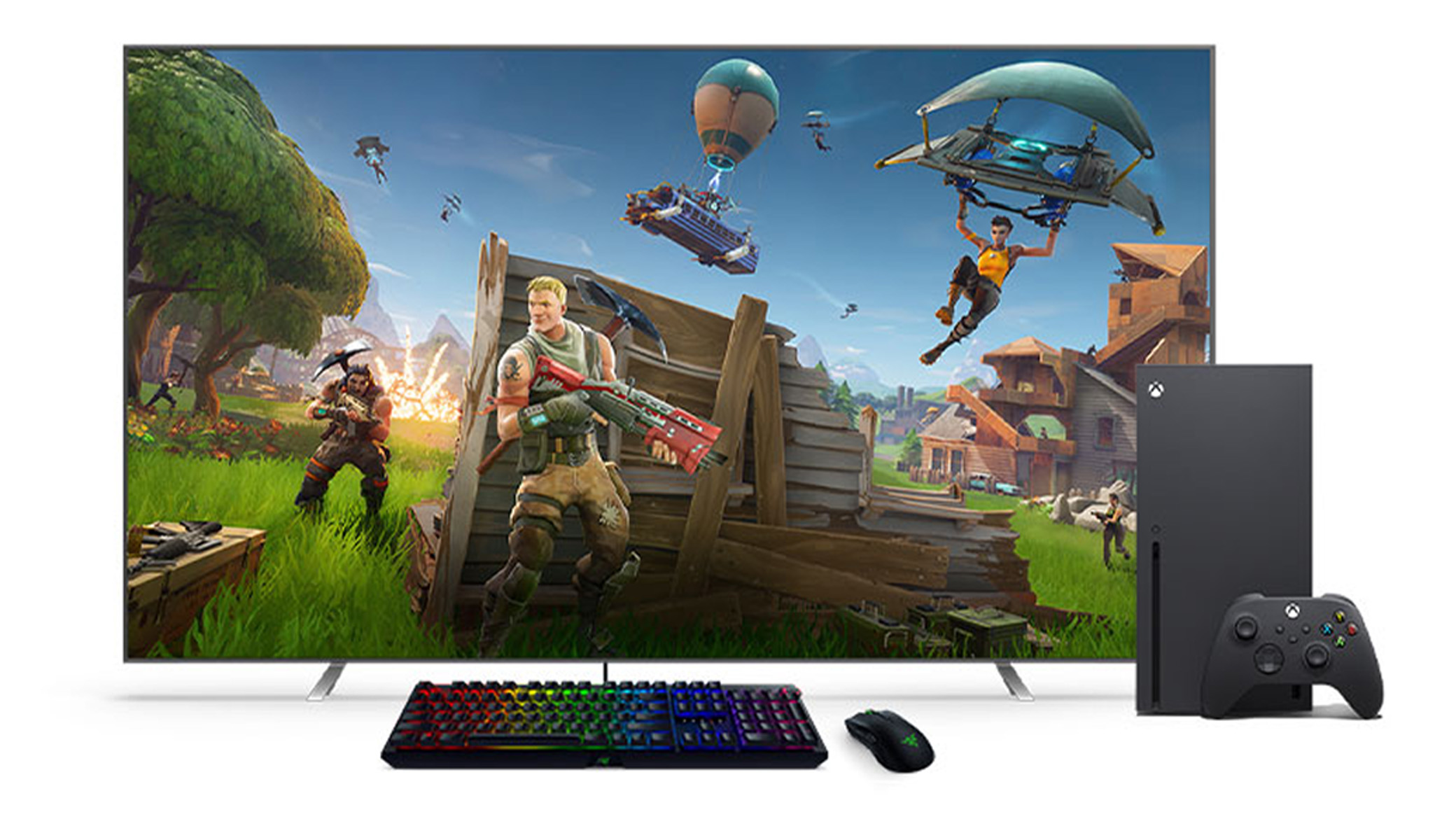 Ett svart tangentbord och en mus framför en Xbox Series X och en TV.