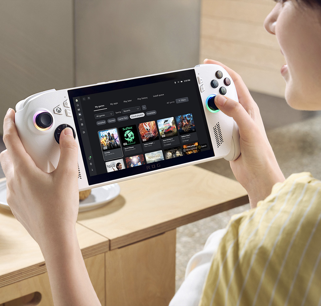 Gamer playing on the ROG Xbox Ally with headphones