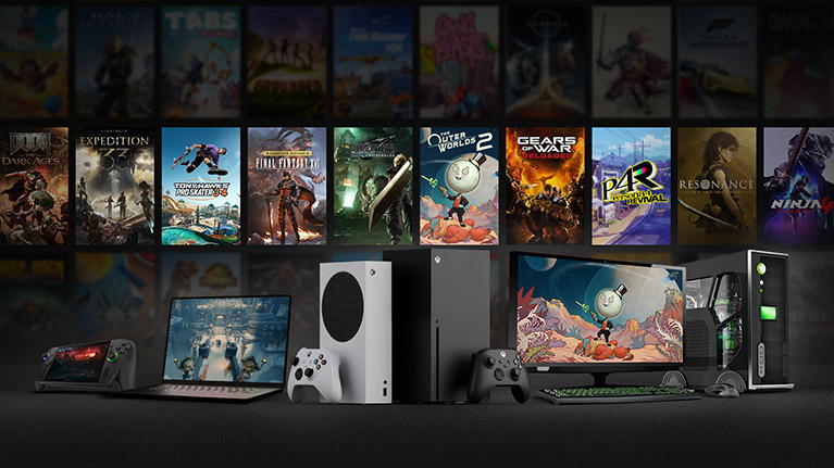 Game box shots behind the ROG Xbox Ally X, a laptop, Xbox Series S and X, and a desktop