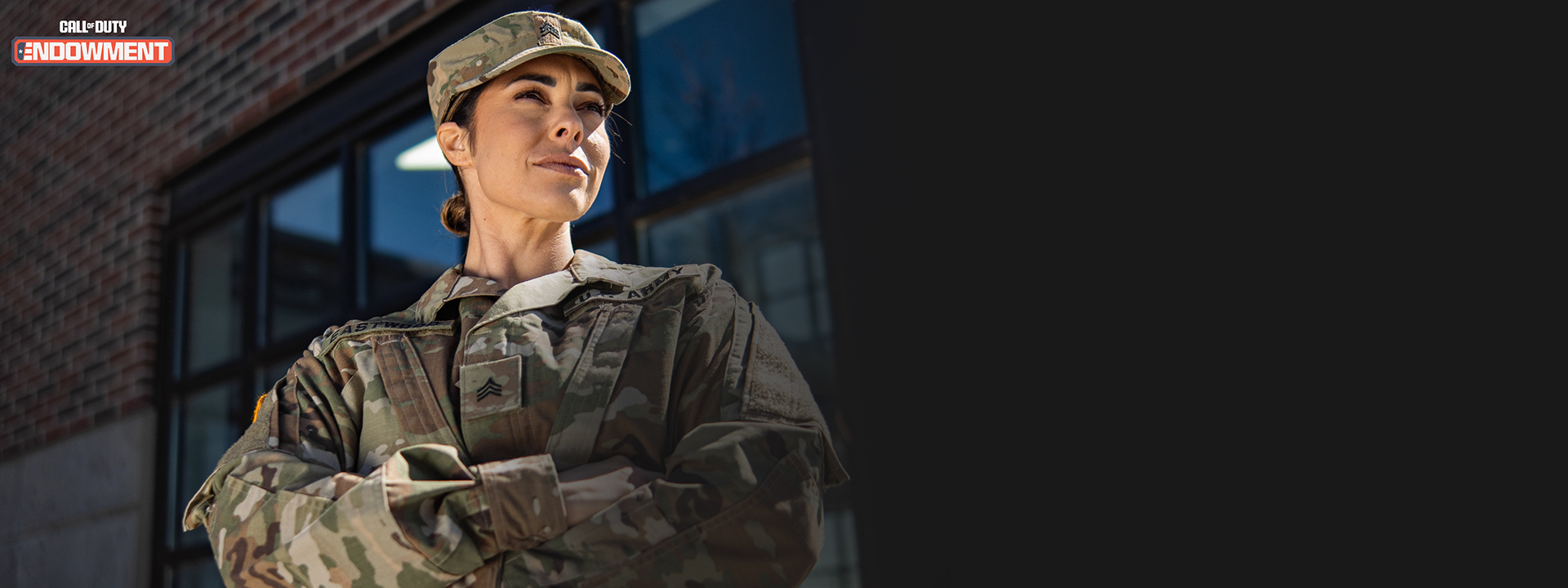 Call of Duty Endowment logo, a woman in an army uniform looking out confidently with her arms crossed.