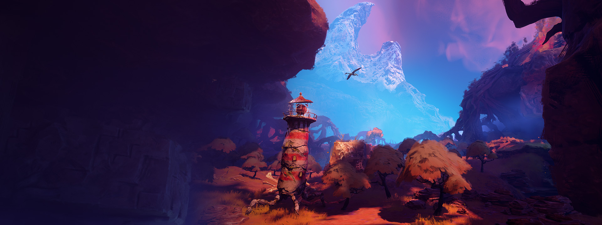 Un phare traverse une forêt basse en direction d'une montagne enneigée au loin.