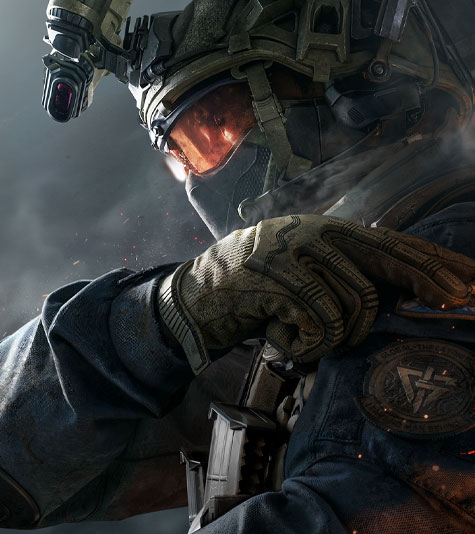 A well equipped and masked soldier tapping their left shoulder looking left. 