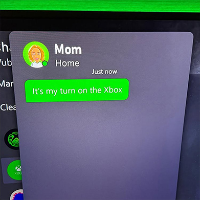 Screenshot showing a chat on the XBOX dashboard that says mom, home, just now: “It’s my turn on the XBOX.”