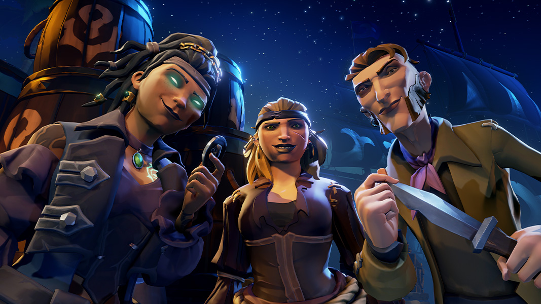 Three pirates look down smirking, on the left a woman with dreadlocks, glowing green eyes, and holding a medallion, in the middle, a blond woman with a scar on her left cheek, and on the right a man with large sideburns holding a dagger menacingly.