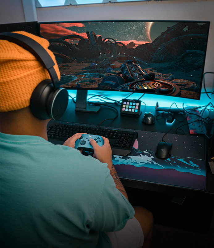A view over the shoulder of a person playing a game on their PC with Xbox on PC.