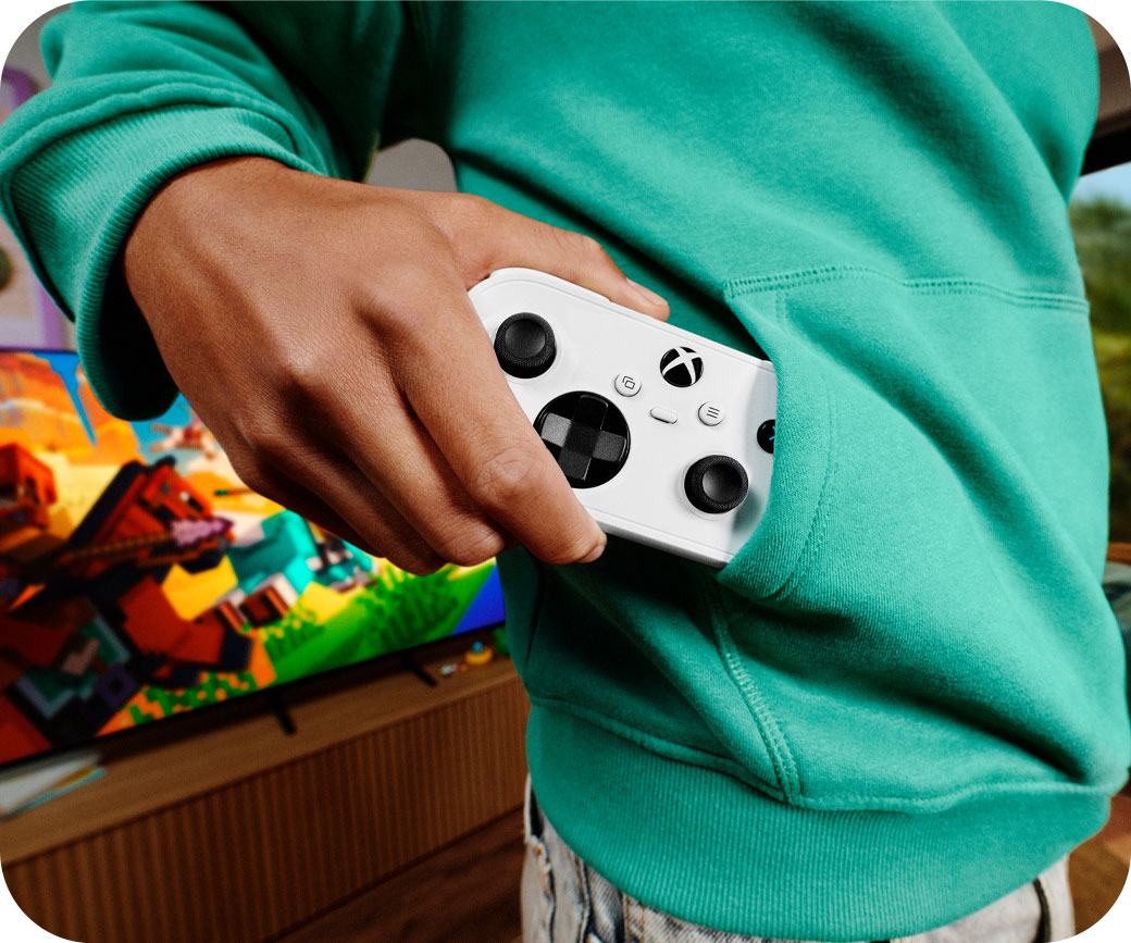 Teenager pulls out the XBOX Nano Controller from their sweatshirt front pocket.