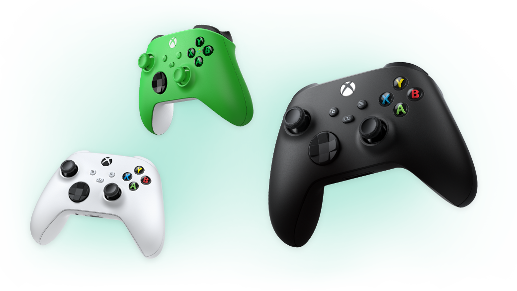 Green, white and black Xbox Wireless controllers against a dark background