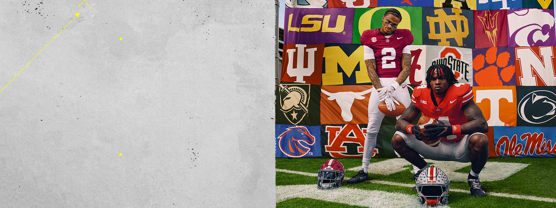 American football players posing on a football field in front of a banner featuring dozens of US college team logos.