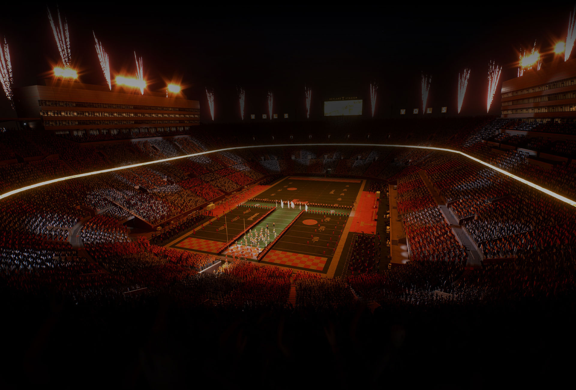 A college football stadium at night with a sell out crowd and fireworks launching into the night sky. 