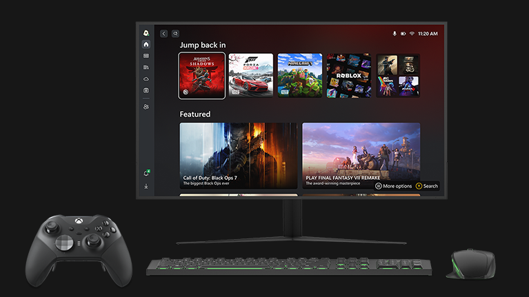 A PC monitor displaying the Xbox Mode UI with an Xbox Elite Wireless Controller, keyboard, and mouse beside it. 