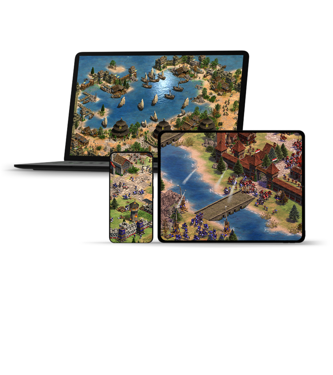 front view of three different monitor screens displaying Age of Empires II DE gameplay