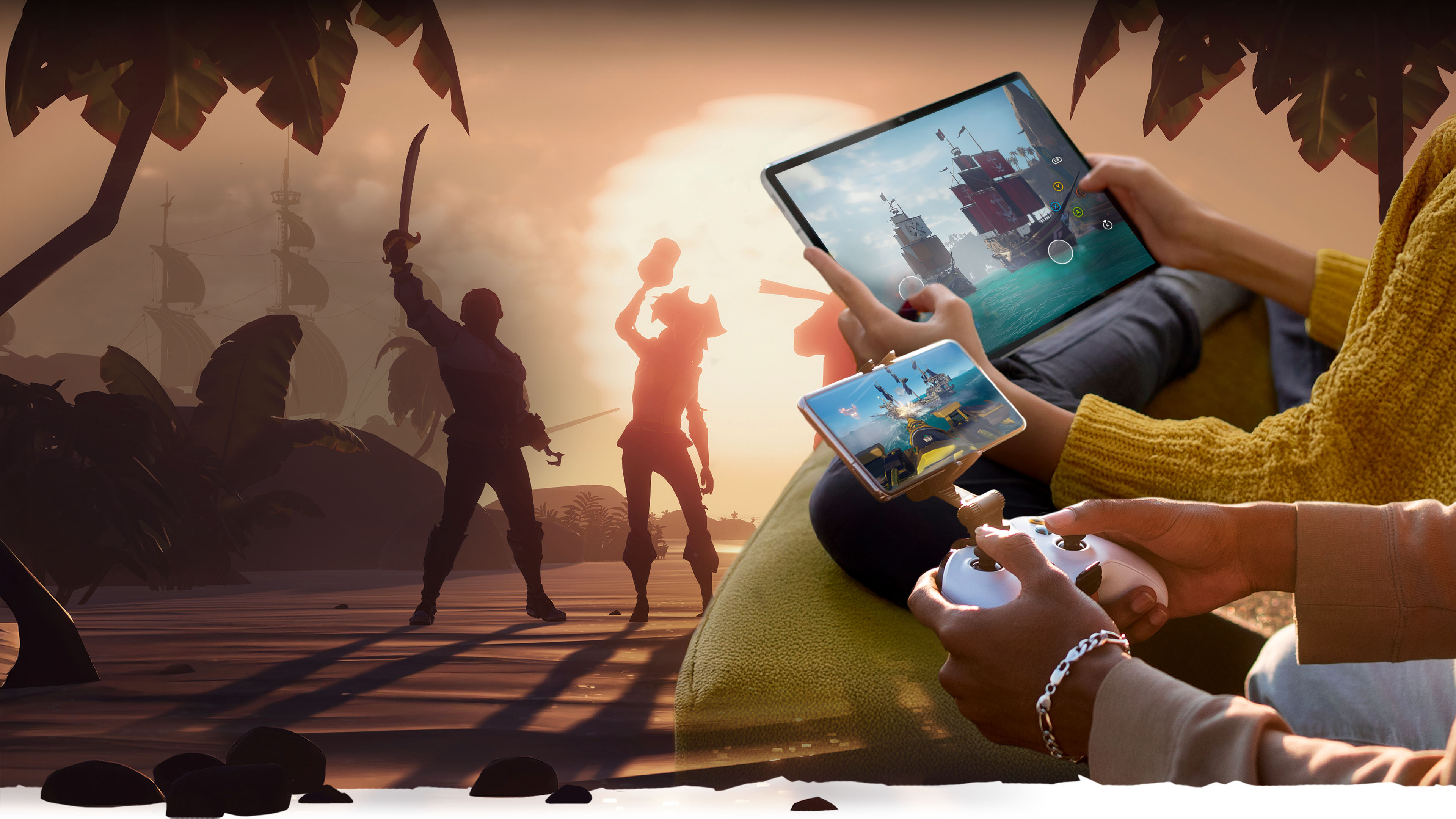 An over the shoulder view of two players holding a mobile phone and tablet with Sea of Thieves gameplay with a pirate crew on a sunset beach in the background.