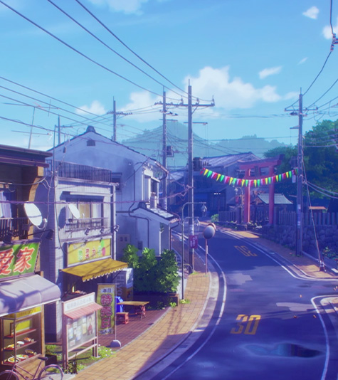 A sunny neighborhood street in Japan with a festive banner hanging from two telephone poles.