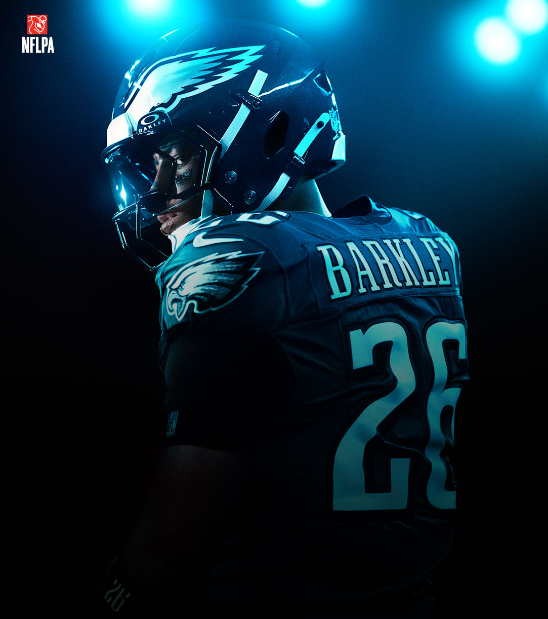 NFLPA Logo, Philadelphia Eagles player Saquon Barkley looks over his shoulder in a glow of neon lights