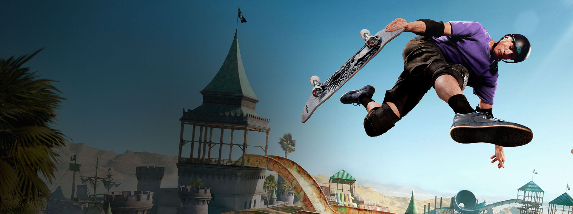 Tony Hawk airwalks over a ramp in an expansive skate park.